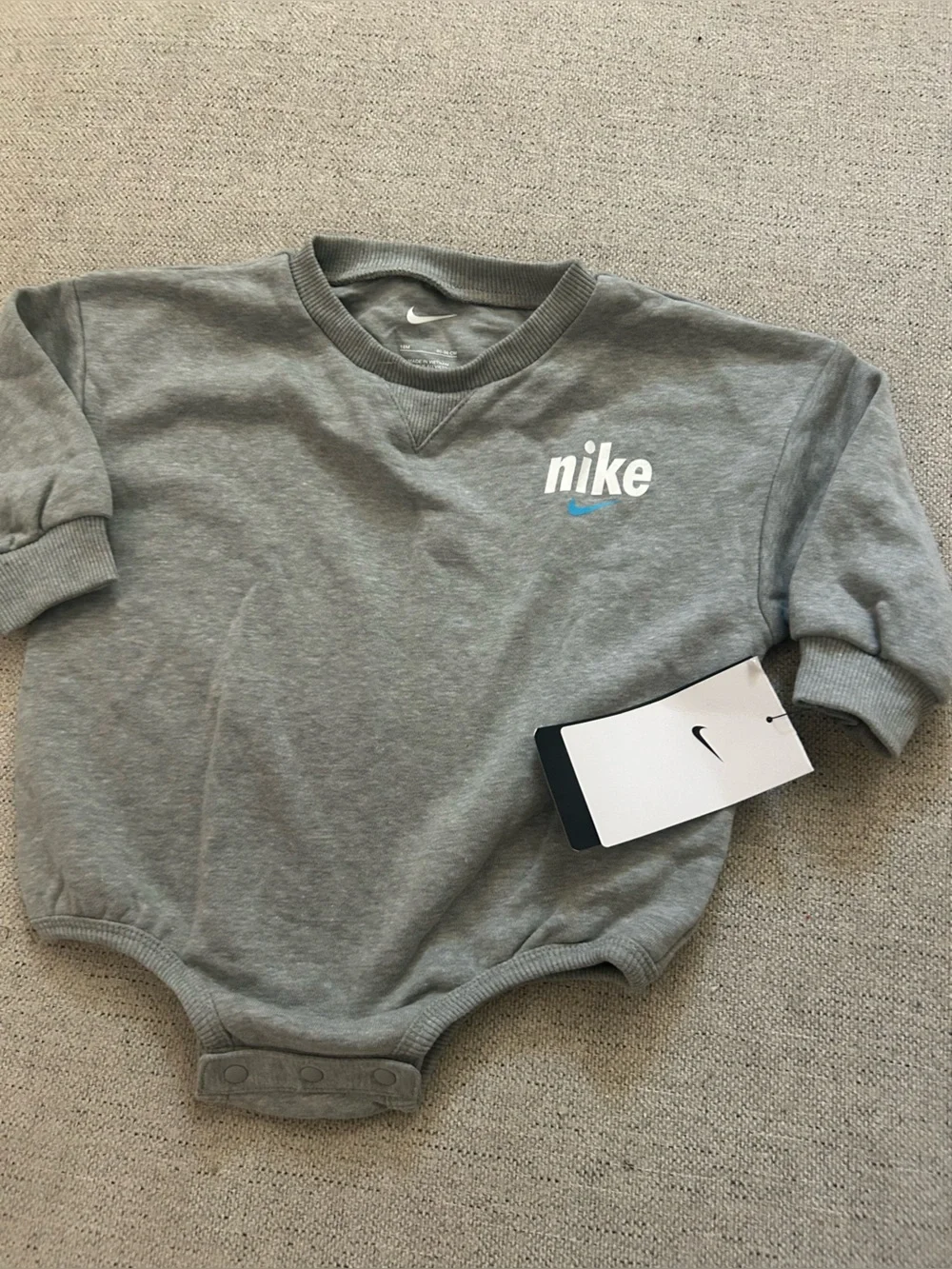 Nike Grey Baby Sweatshirt Bodysuit with White Logo and Blue Swoosh
